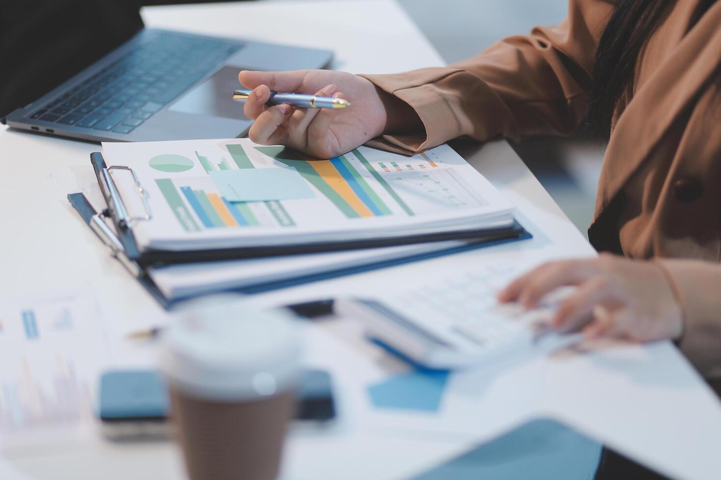 Person thoughtfully reviewing paper financial statements and calculations